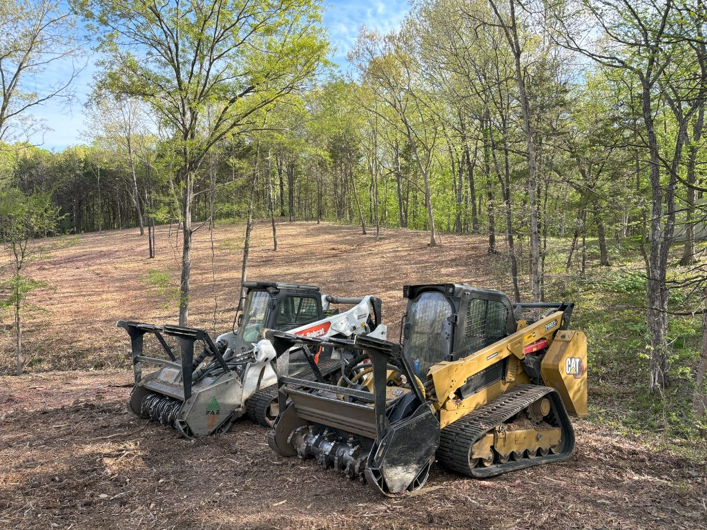 a group of construction vehicles in a forest